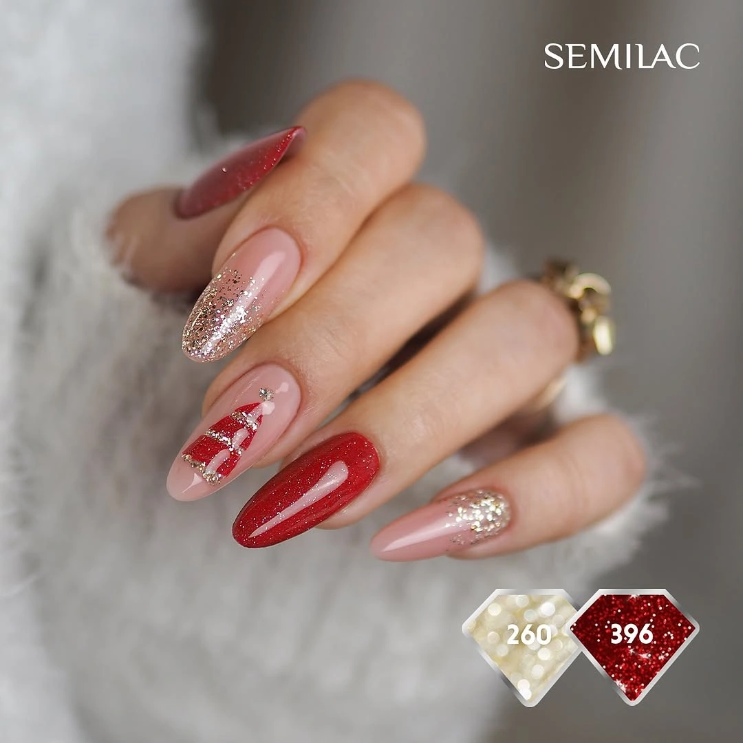 Red glitter almond nails with gold sparkle and a festive red and white accent.