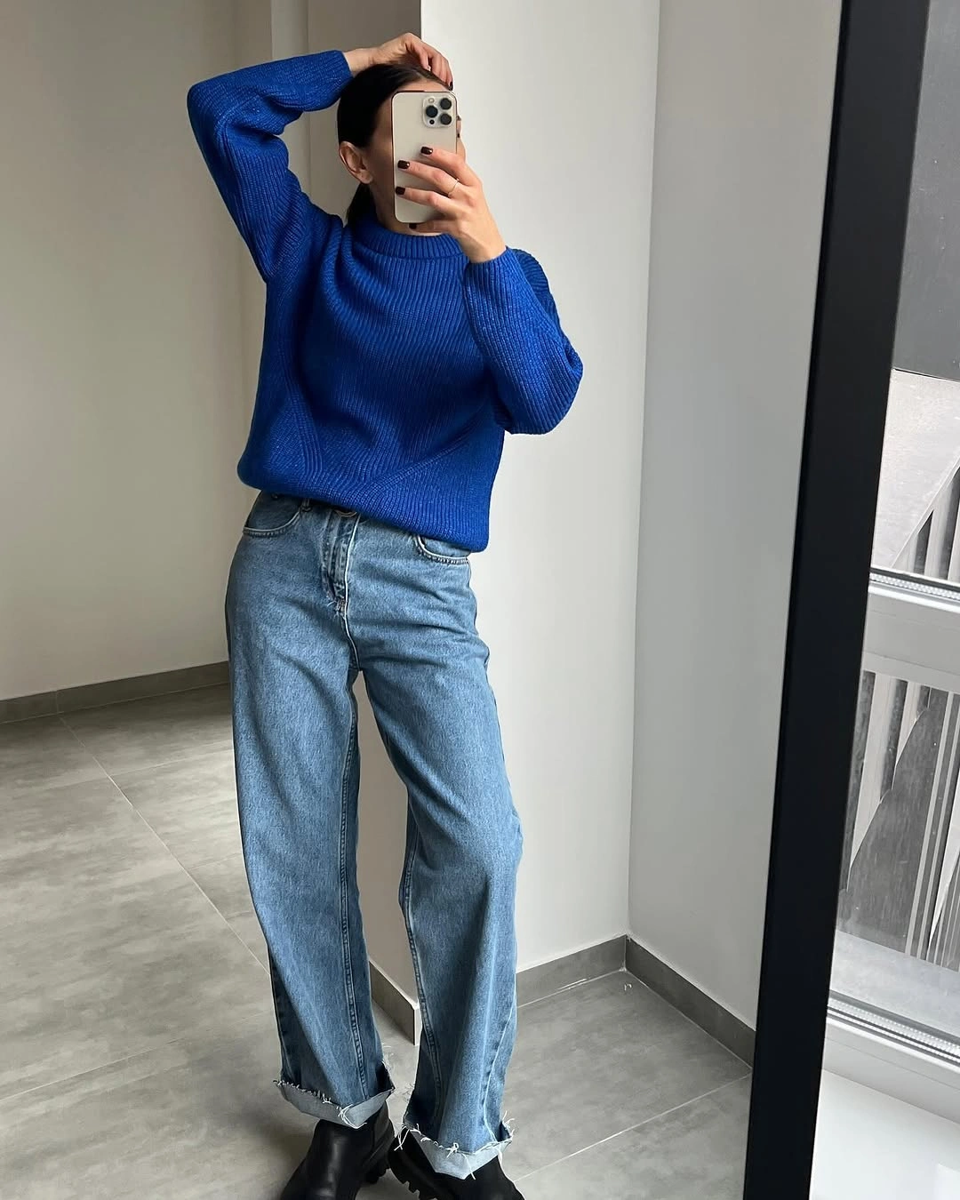 Bright cobalt blue ribbed sweater with wide-leg jeans and black ankle boots.