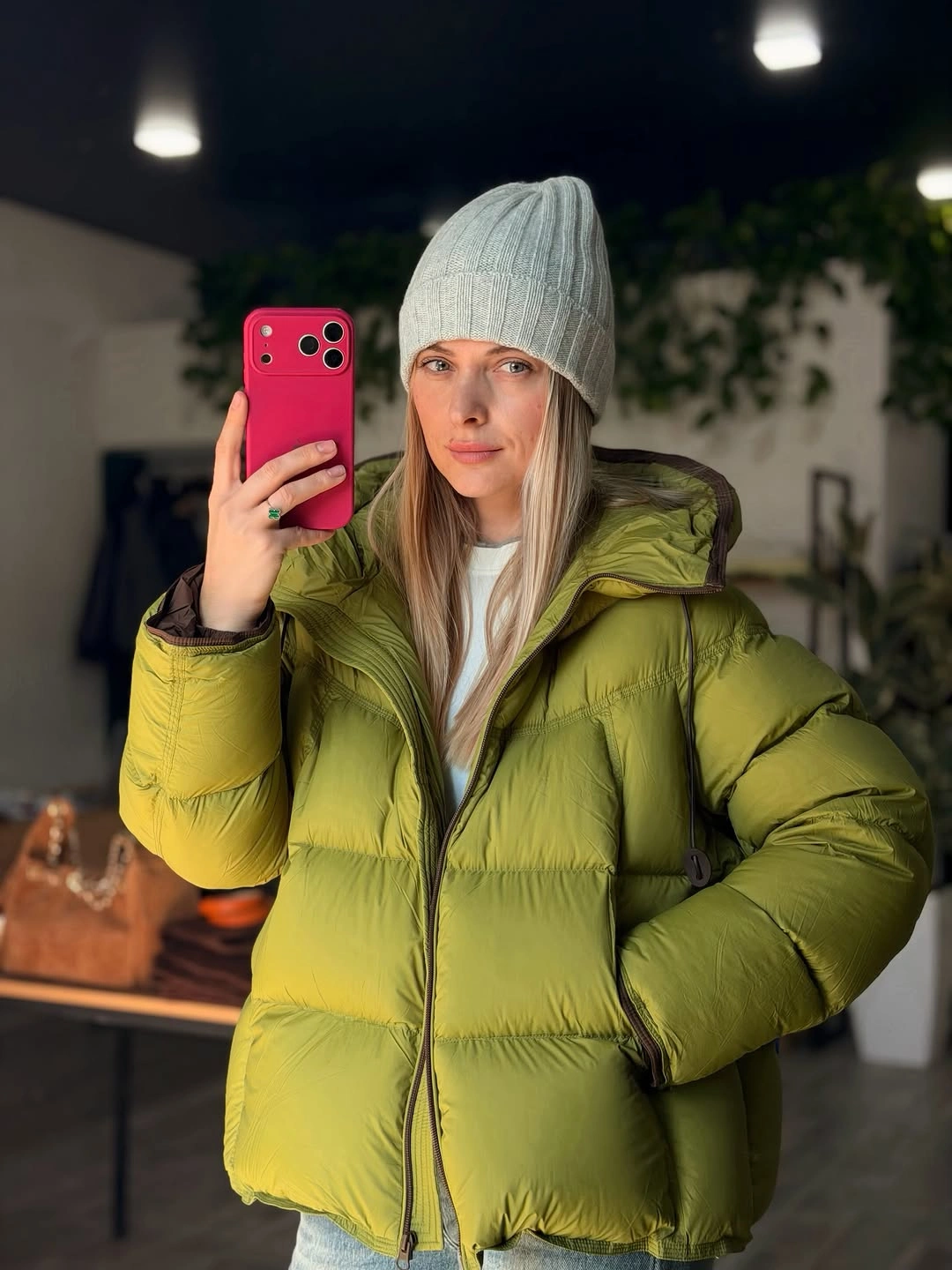 Bright yellow green oversized puffer jacket with light gray ribbed beanie.