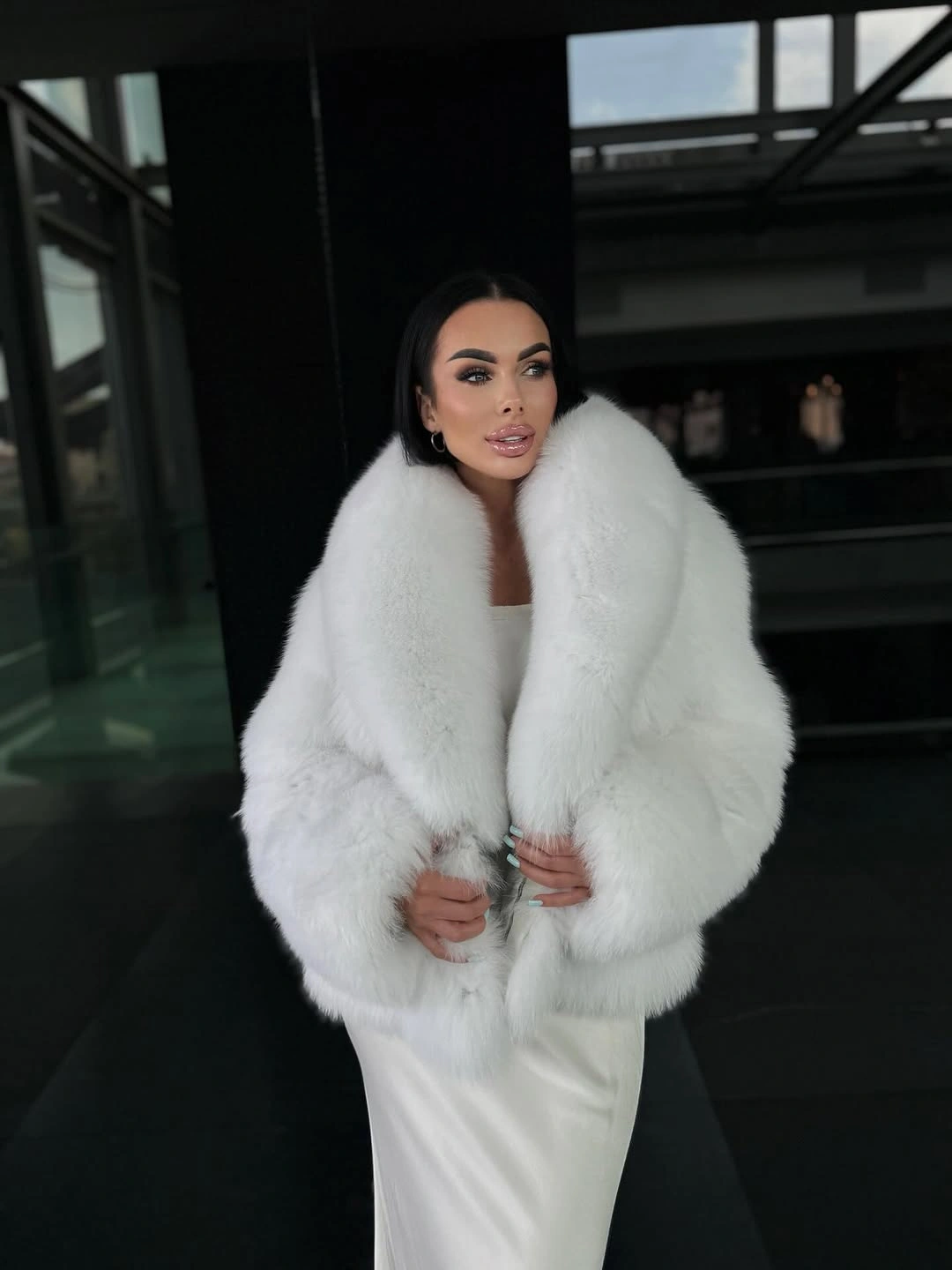 Voluminous fluffy white jacket with oversized plush collar and long ivory dress.